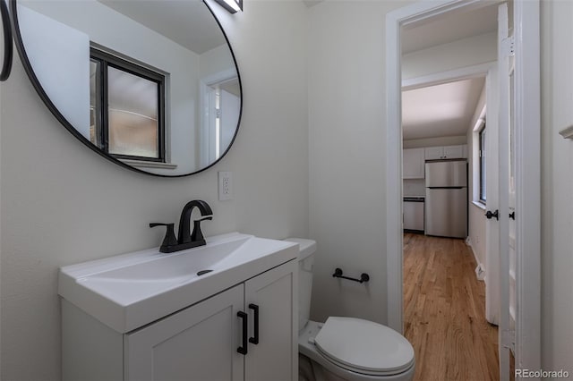 6176 Ammons St, Arvada, CO 80004 - half bathroom featuring wood finished floors and vanity