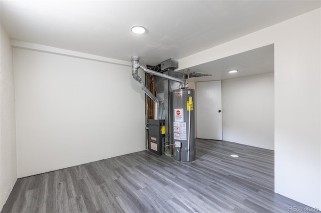 6176 Ammons St, Arvada, CO 80004 - finished below grade area with water heater, wood finished floors, and heating unit