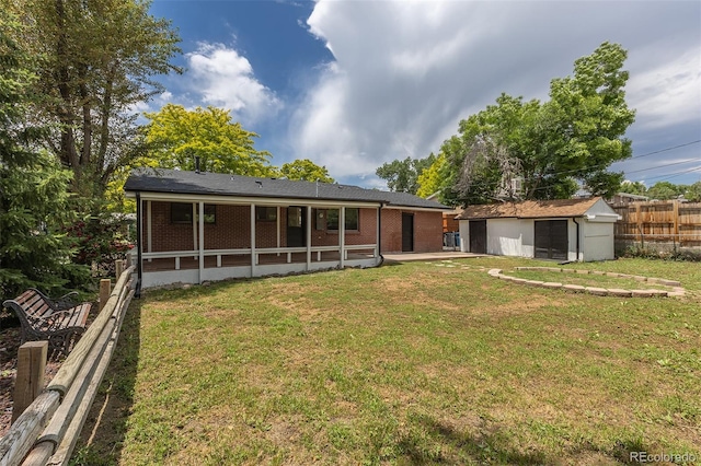 6176 Ammons St, Arvada, CO 80004 - rear view of property featuring an outbuilding, brick siding, and a sunroom