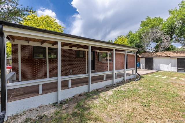 6176 Ammons St, Arvada, CO 80004 - back of property featuring an outbuilding, a yard, and brick siding