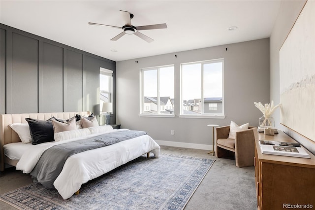 carpeted bedroom featuring ceiling fan and multiple windows