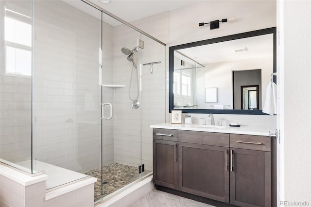 bathroom featuring vanity and a shower with shower door