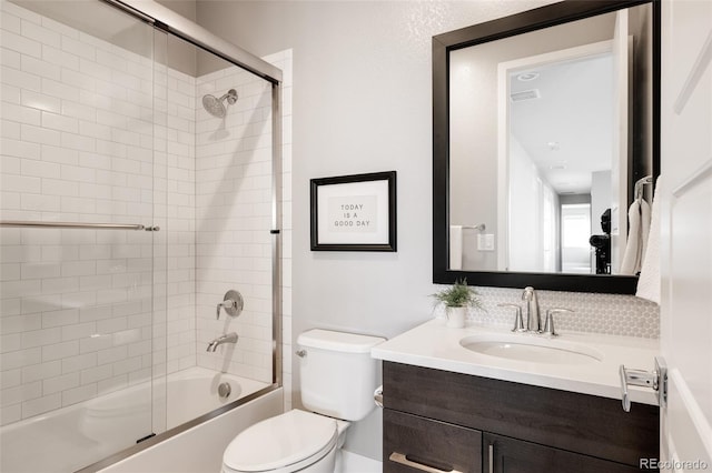 full bathroom with shower / bath combination with glass door, vanity, and toilet