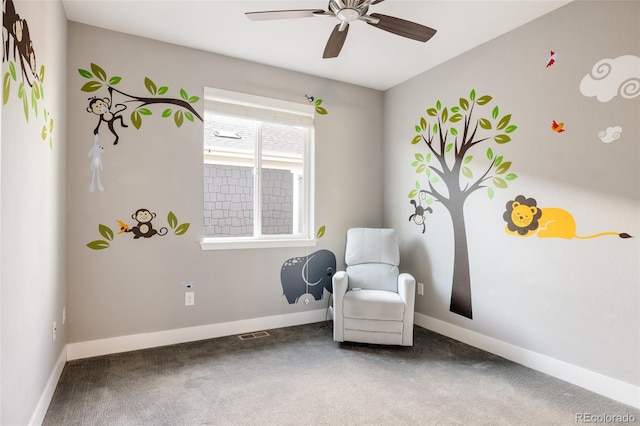 sitting room with carpet and ceiling fan