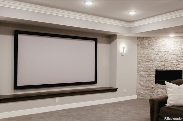 carpeted home theater featuring crown molding