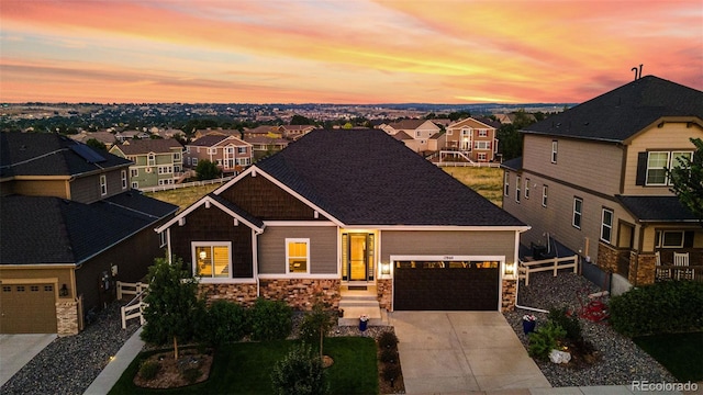 craftsman inspired home featuring an attached garage, stone siding, a residential view, and concrete driveway