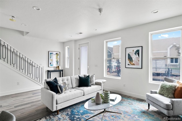 living room featuring hardwood / wood-style floors, a healthy amount of sunlight, and a textured ceiling