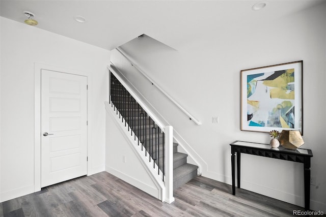 stairs featuring wood-type flooring