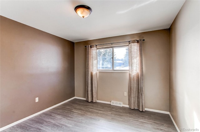 empty room with dark wood-type flooring