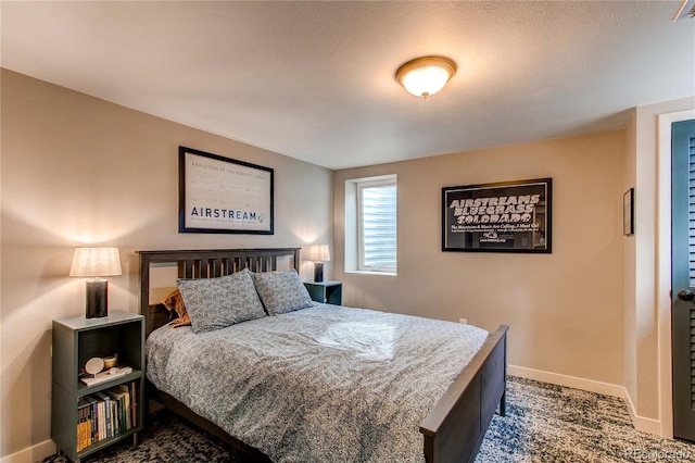 bedroom with dark colored carpet