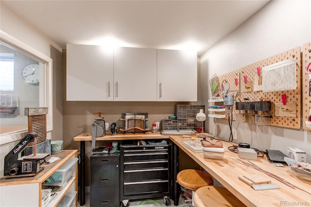 kitchen with wood counters and white cabinetry