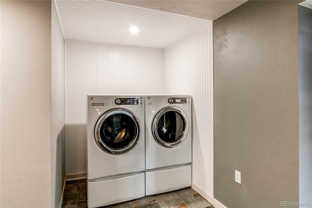 clothes washing area with washing machine and dryer