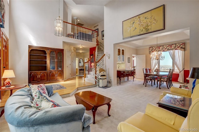 living room with carpet flooring, a high ceiling, and a notable chandelier