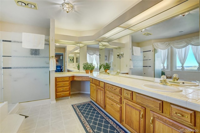 bathroom featuring tile patterned flooring, vanity, and a shower with door