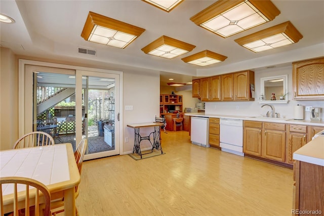 kitchen with dishwasher, light hardwood / wood-style floors, and sink