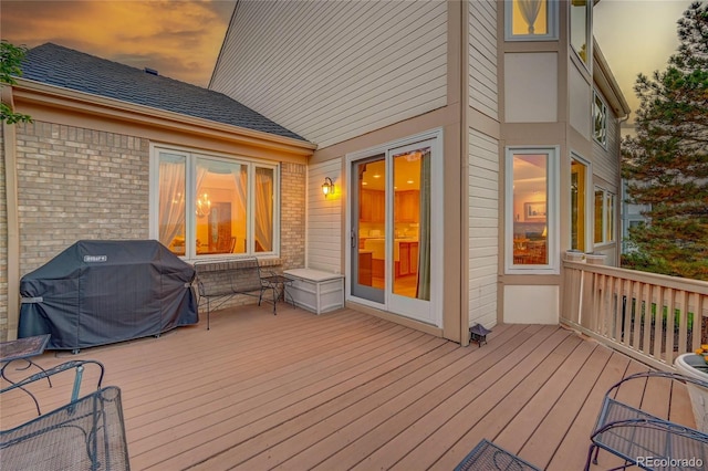 deck at dusk with area for grilling