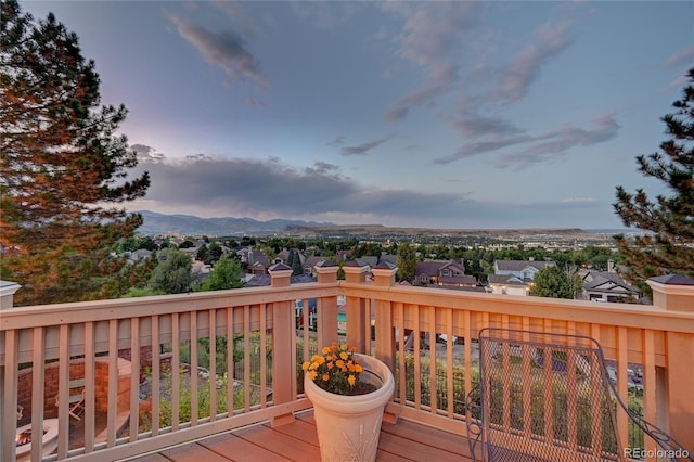 deck at dusk featuring a mountain view