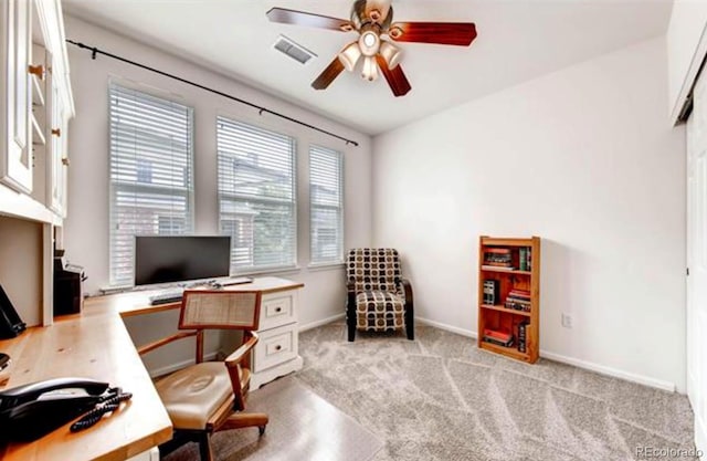 carpeted office space with ceiling fan