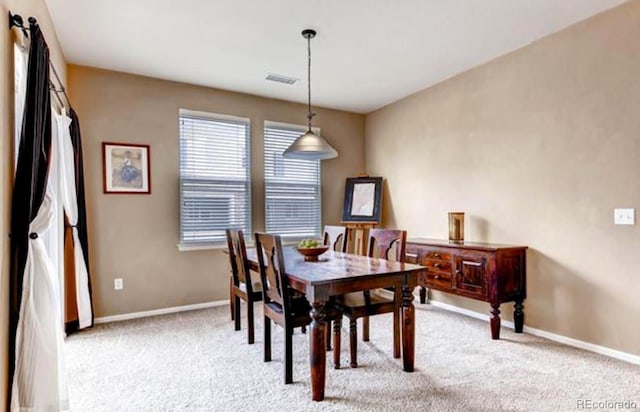 dining room with light colored carpet