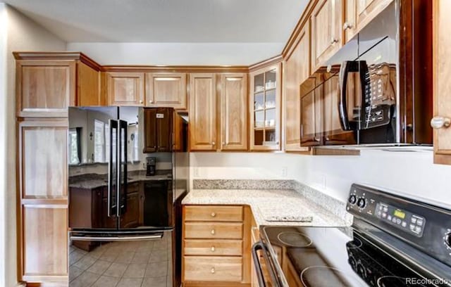 kitchen with black appliances and tile patterned floors