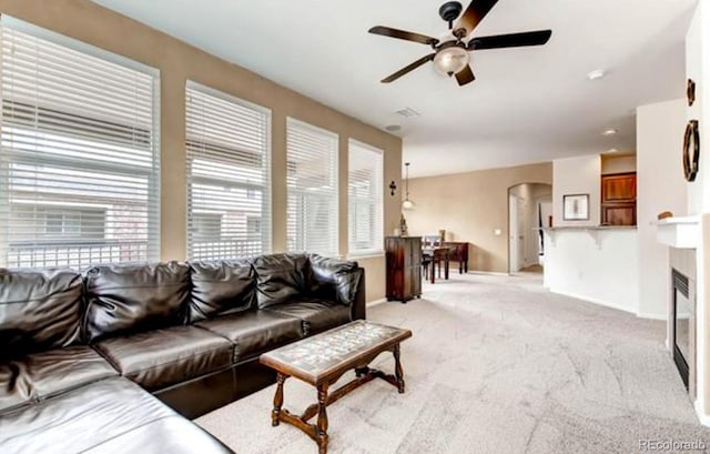 living room with light colored carpet and ceiling fan