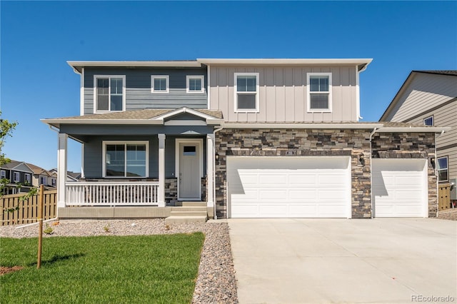 view of front of home with driveway, stone siding, a porch, fence, and board and batten siding