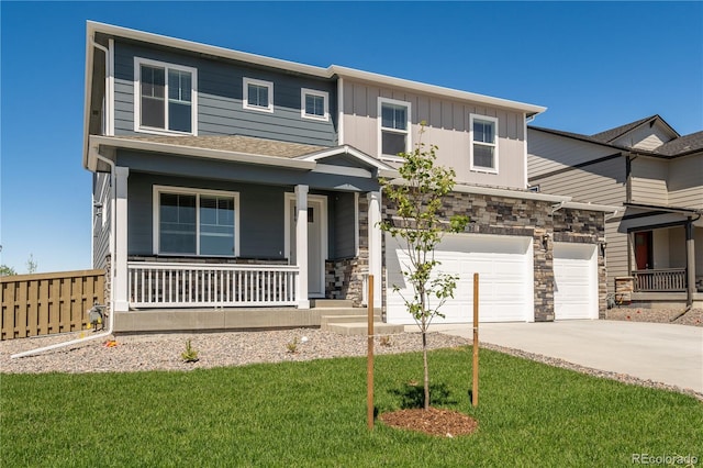 view of front of house featuring a porch, an attached garage, concrete driveway, stone siding, and board and batten siding