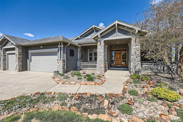 craftsman house with a porch, an attached garage, stucco siding, stone siding, and concrete driveway