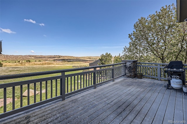 wooden terrace featuring grilling area and a yard