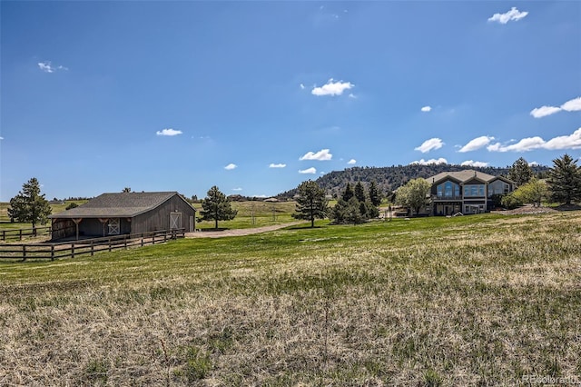 view of yard featuring an outbuilding and a view of rural / pastoral area