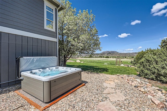 view of patio featuring a mountain view and a hot tub