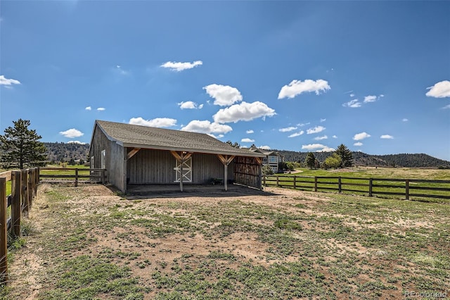 view of outdoor structure featuring a view of countryside, an exterior structure, and an outdoor structure