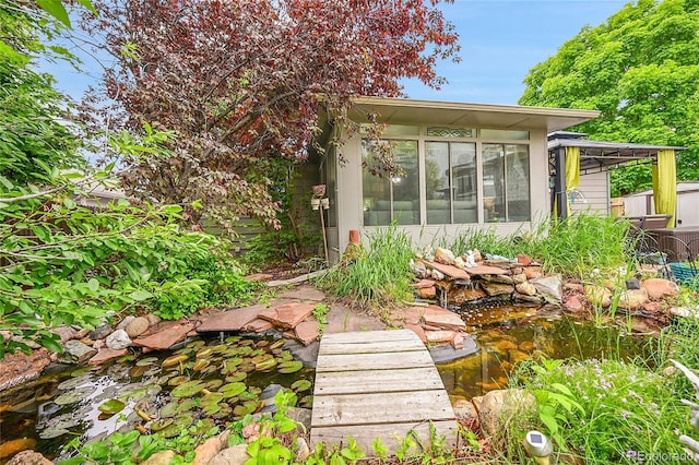 5323 E Sandpiper Ave, Castle Rock, CO 80104 - view of yard with a sunroom and a garden pond