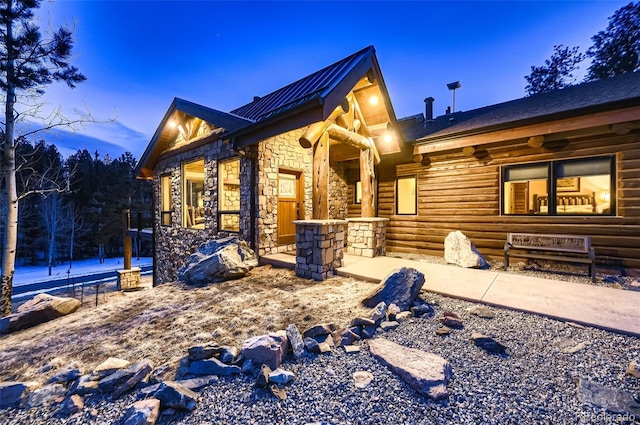 view of side of home with a ceiling fan and stone siding