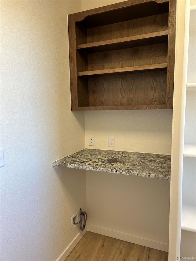 washroom with wood-type flooring and washer hookup