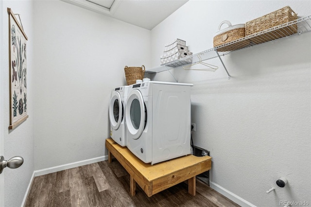 laundry room featuring wood finished floors, laundry area, attic access, separate washer and dryer, and baseboards