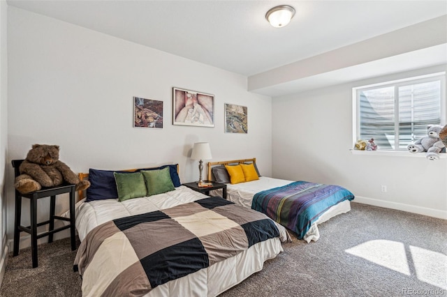 carpeted bedroom featuring baseboards