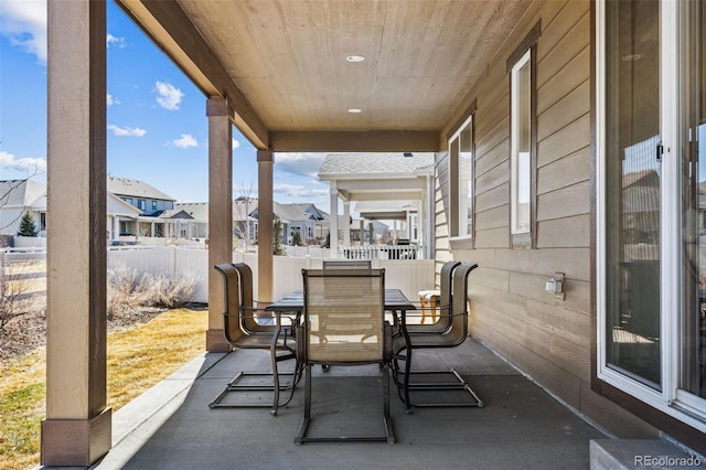 view of patio / terrace featuring outdoor dining area, a residential view, and a fenced backyard