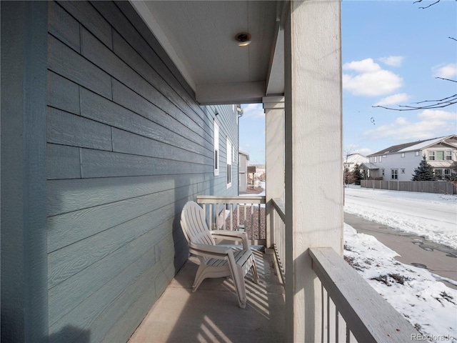 view of snow covered back of property