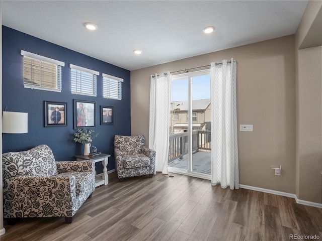 living area with hardwood / wood-style floors