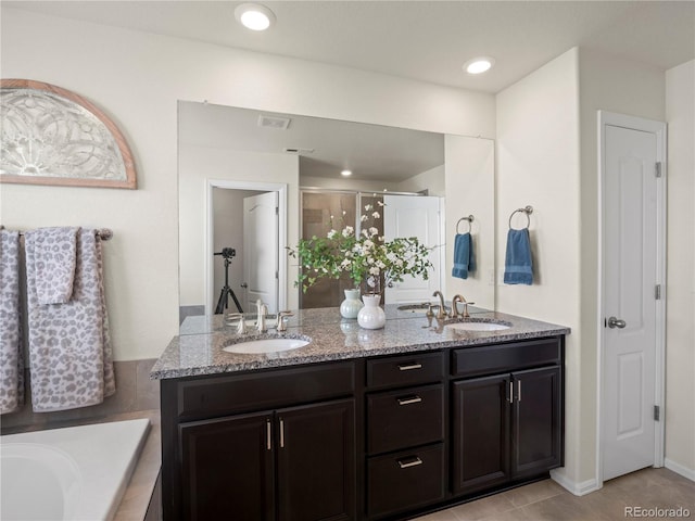 bathroom with tile patterned flooring, vanity, and a shower with shower door