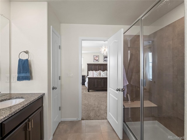 bathroom featuring tile patterned flooring, vanity, and walk in shower