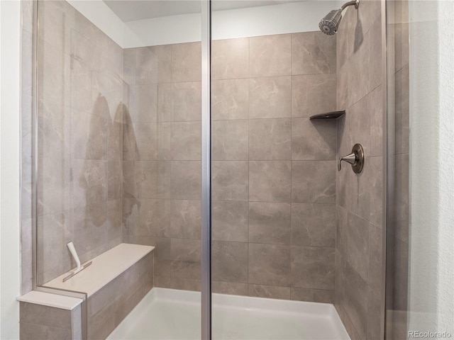 bathroom with a tile shower