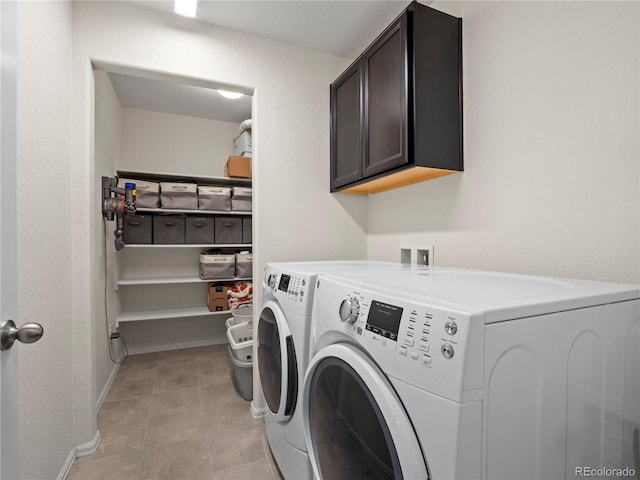 laundry room with cabinets and washing machine and dryer