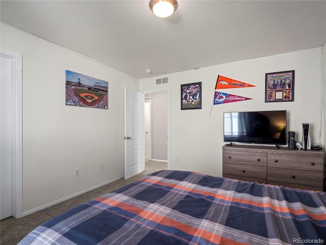 carpeted bedroom with a textured ceiling