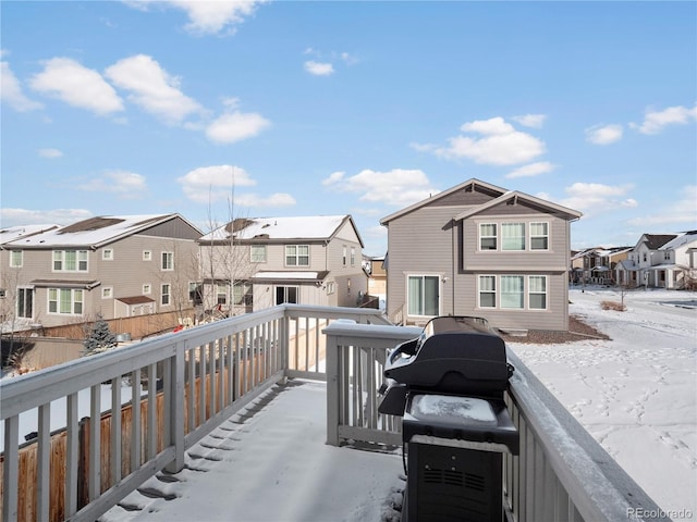 snow covered deck featuring area for grilling