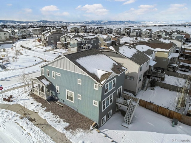 snowy aerial view with a mountain view