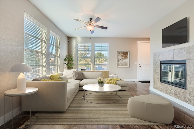 living room with ceiling fan, hardwood / wood-style flooring, and a fireplace