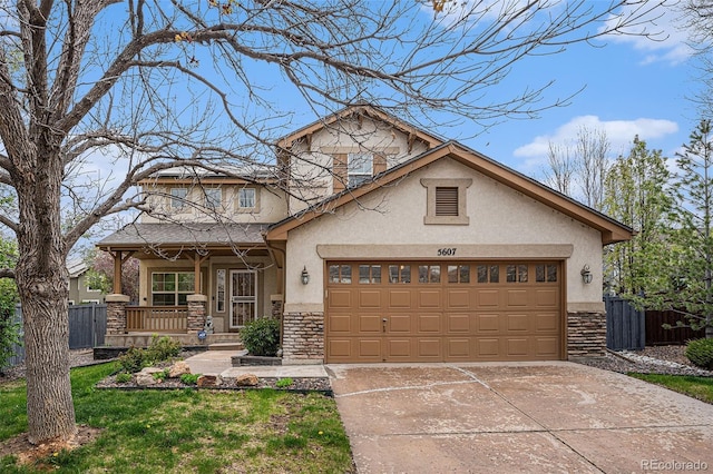 5607 S Gray St, Littleton, CO 80123 - craftsman-style house with covered porch, stone siding, stucco siding, an attached garage, and driveway