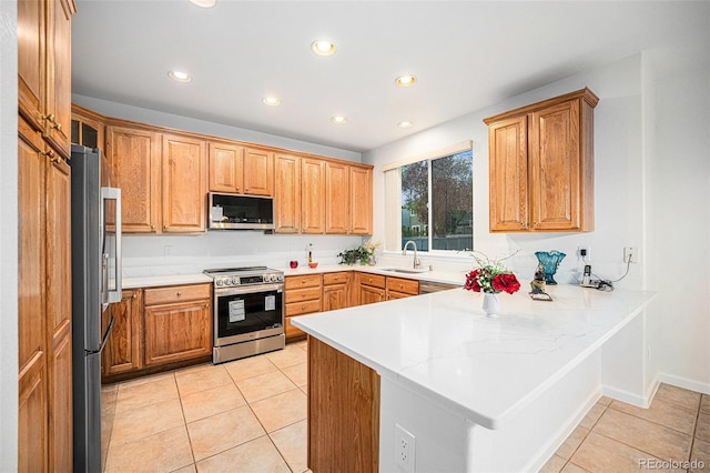 5607 S Gray St, Littleton, CO 80123 - kitchen featuring a peninsula, recessed lighting, a sink, appliances with stainless steel finishes, and light tile patterned floors